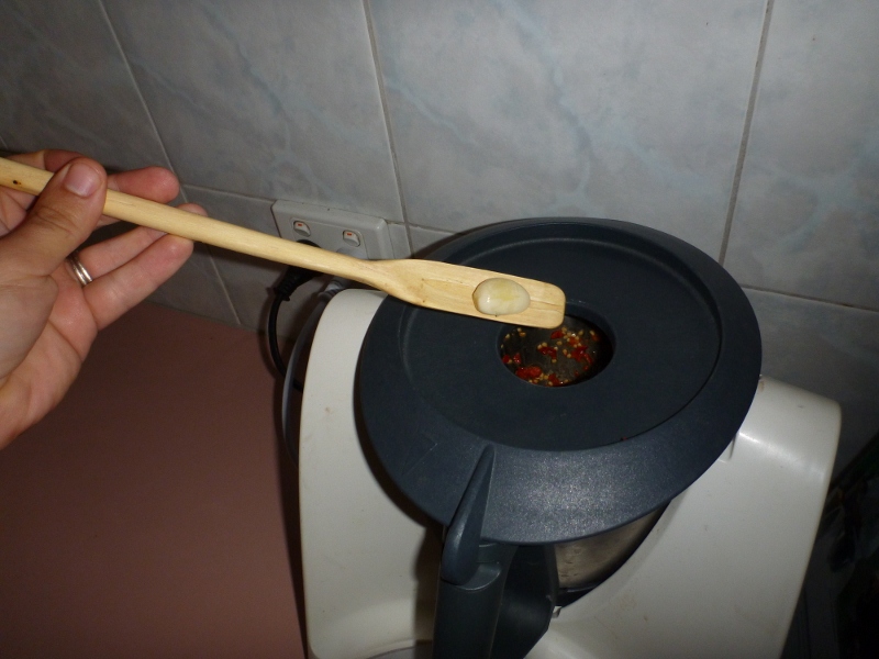 adding garlic to chilli inside the thermal mix