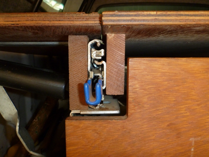 timber rails supporting fridge slide