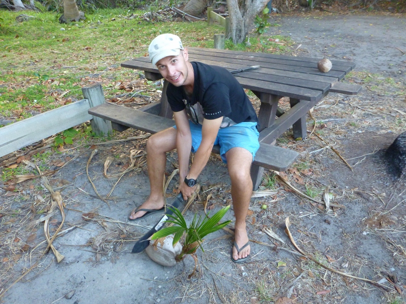 chopping sprouted coconut at chili beach